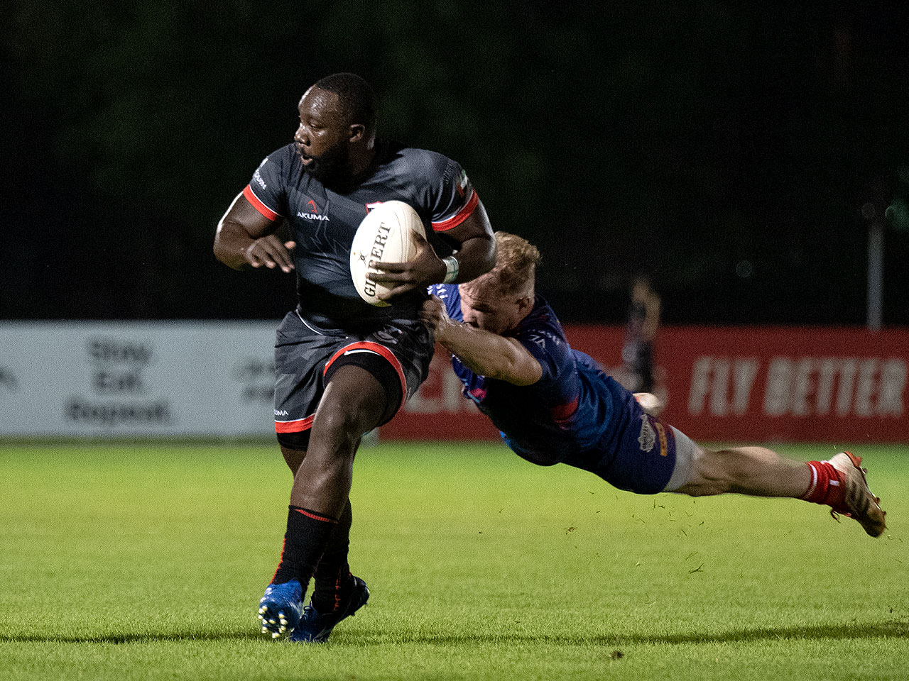 Brad Owako on the charge with a rugby ball
